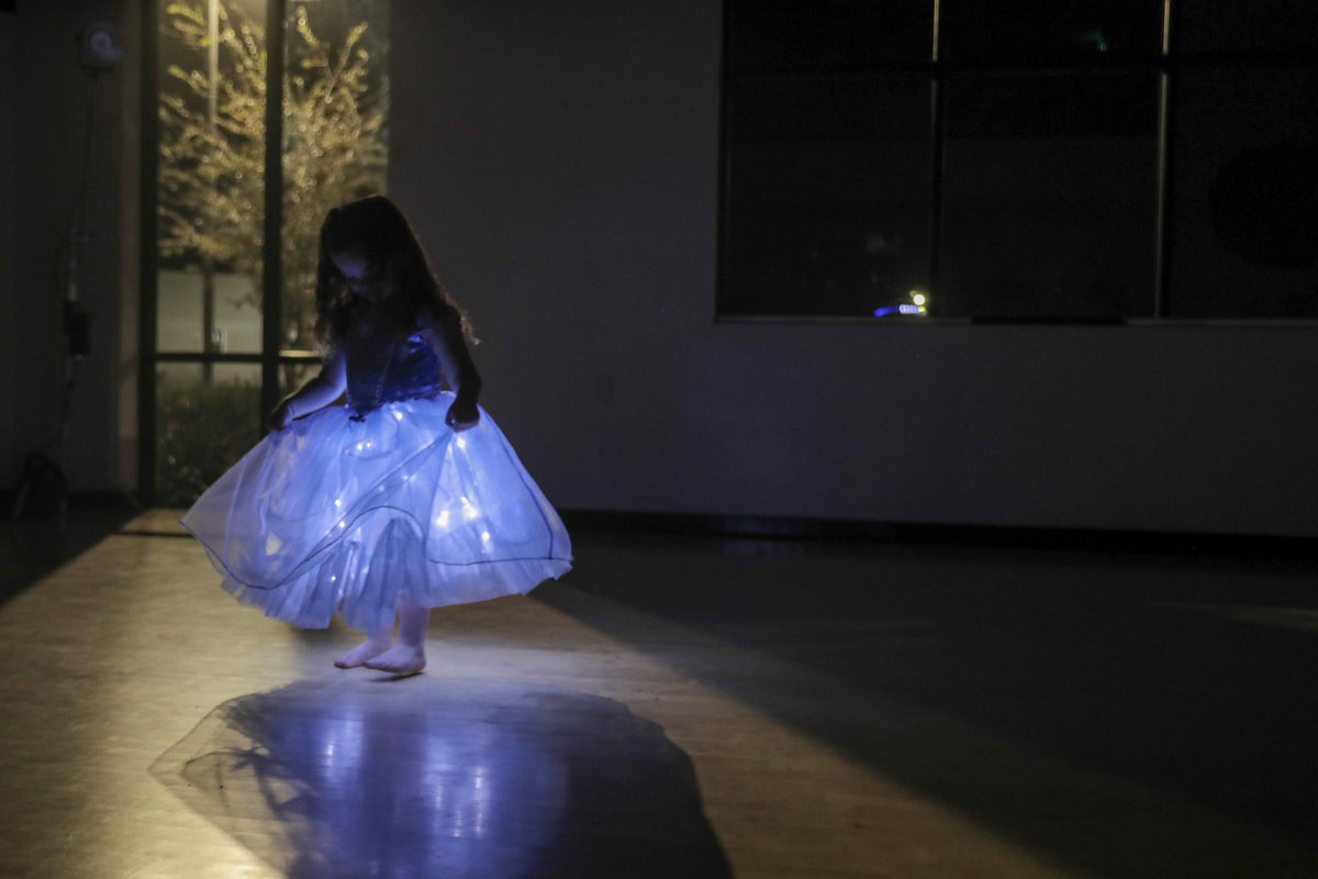 Starlit Ball in Celeste glowing mid-spin in a dark studio