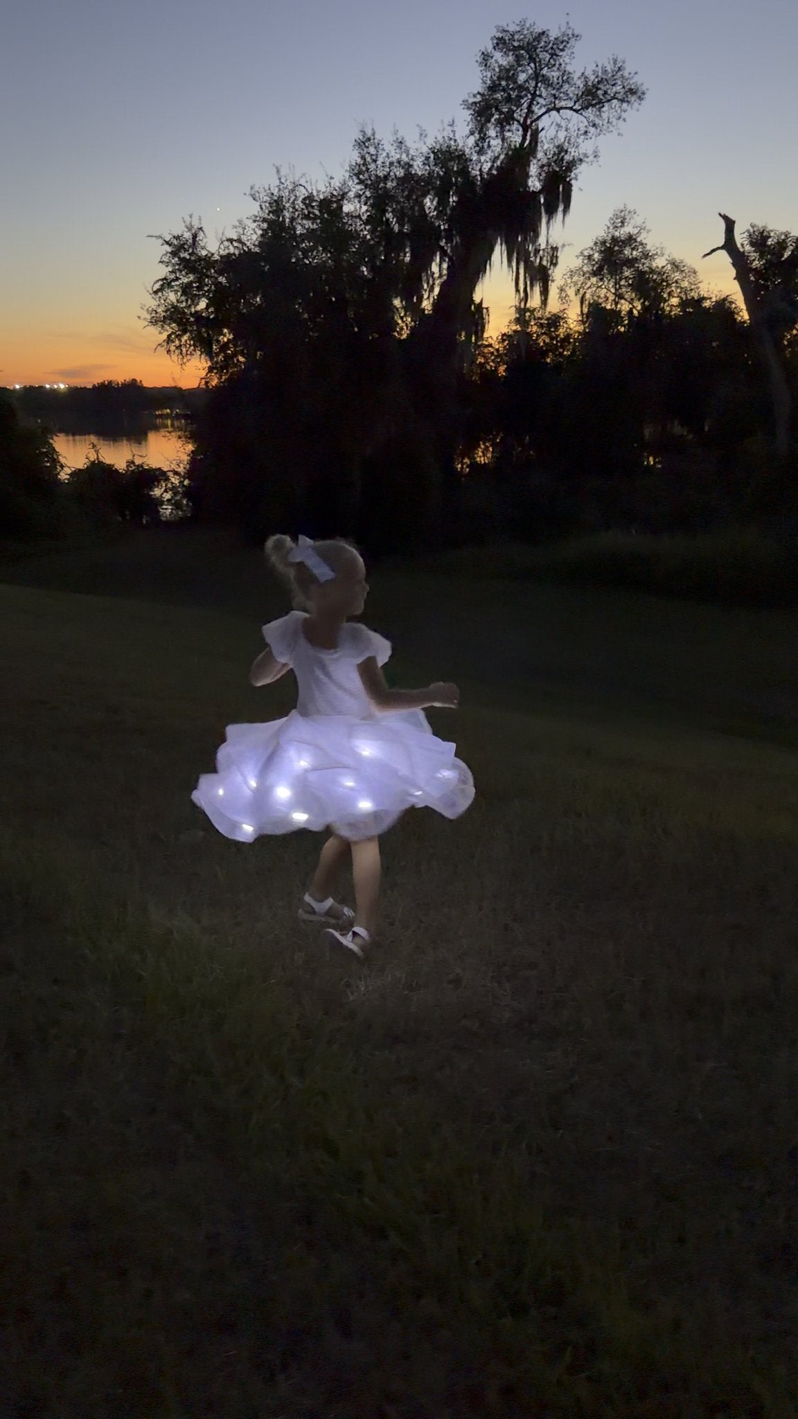 Moonbeam in Ivory glowing mid-spin at dusk