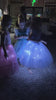 Friends spinning in glowing pink and blue SpinBrite dresses