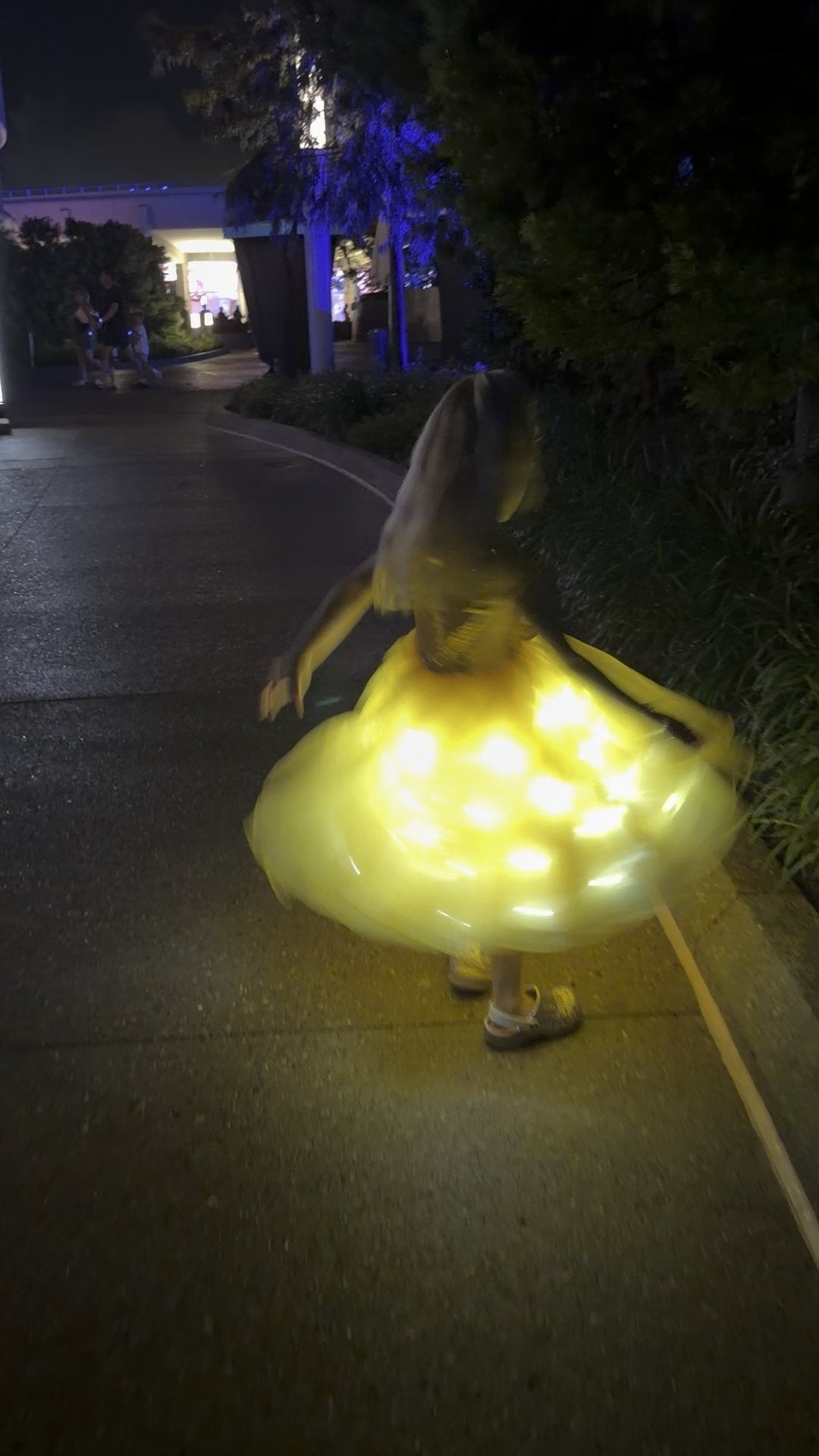 Starlit Ball in Marigold glowing mid-spin at night